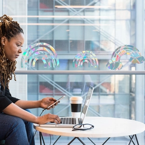 Rainbow prism static window film with holographic cloud pattern in a bright home office setting