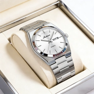 Close-up of elegant men's steel watch with dual calendar display and white dial