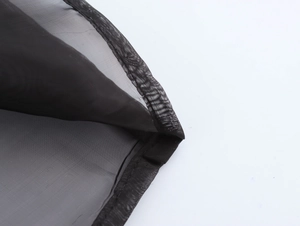 Detailed view of black organza fabric featuring fine stitching and semi-transparent mesh texture
