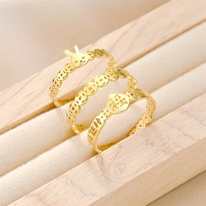 Detailed view of three gold-plated titanium steel rings with Chinese zodiac and fortune motifs