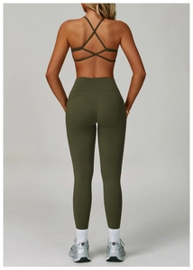 Detail of cross-back sports bra and high-waisted leggings with butt-lifting seams