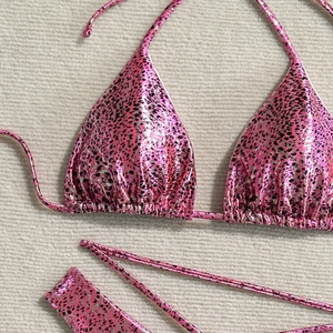 Flat lay of pink metallic leopard print bikini set with side tie-up details