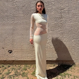 Détail d'une robe maxi blanche ajustée en dentelle avec manches longues transparentes
