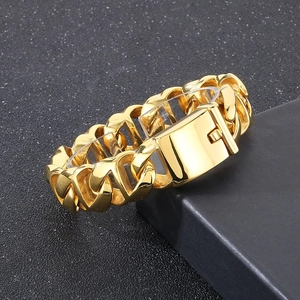 Detail of gold Cuban link bracelet with large square buckle on a dark background
