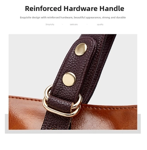 Leather handbag handle detail featuring reinforced hardware and durable metal rings.
