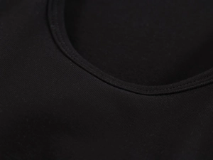 Detail of double-needle stitching and ribbed neckline on black skin-friendly fitness tank top