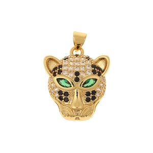 Macro shot of a gold-toned leopard head pendant with sparkling green and black stones