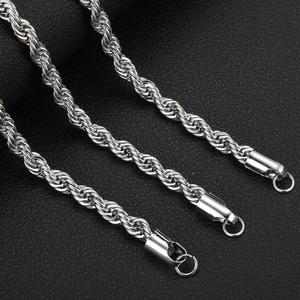 Detailed macro view of three silver stainless steel twisted rope chains on black leather