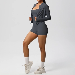 Close-up of charcoal grey high-stretch yoga set featuring a zip cardigan and shorts