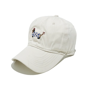 Detail of embroidered dachshund cartoon pattern on ivory cotton baseball cap