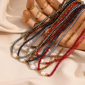 Artistic detail of beaded necklaces with freshwater pearls on a wooden hand model