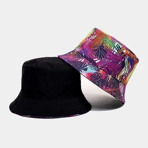 Dual-style reversible sun bucket hat featuring plain black and tropical plant print patterns