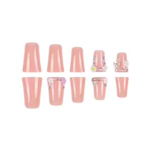 Pink press-on nail set with 3D white flowers, pearls, and rhinestones in long coffin shape