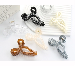 Flat lay of elegant hollow bow claw clips in six jelly colors with sturdy metal springs