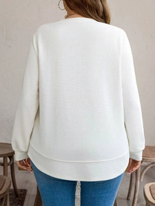Back view of a white waffle knit long-sleeve sweatshirt in a loose casual fit for women
