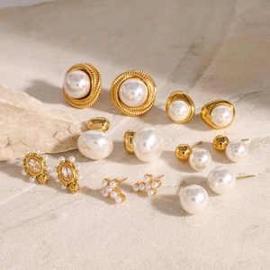 Elegant 7-pair titanium steel pearl earrings set in 18K gold finish on a stone surface