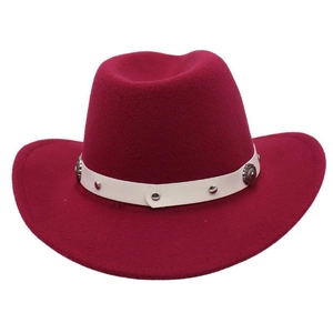 Detail of wool felt cowboy hat with white leather band and vintage metal studs