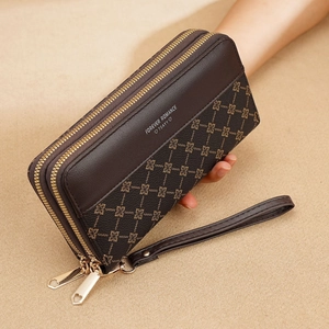 Detail of vintage brown long wallet with floral pattern, gold zippers, and wrist strap