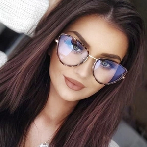 Close-up of cat-eye frames with tortoiseshell pattern and gold metal temples on a model