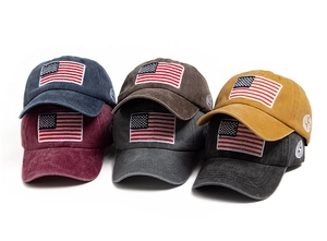 Multiple colors of vintage washed cotton baseball caps with American flag embroidery detail