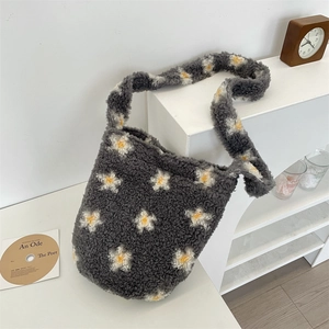 Detailed view of dark grey plush bucket bag with daisy pattern and soft fleece texture