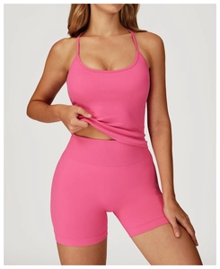 Close-up of pink ribbed knit yoga set with cross back camisole and high waist shorts