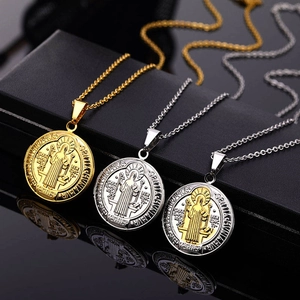 Detailed close-up of Saint Benedict religious pendant necklaces in gold and silver finish