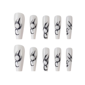Long coffin-shaped press-on nails featuring black and white gothic flame patterns