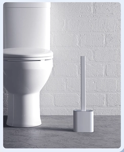 Minimalist white silicone toilet brush with compact storage base in modern bathroom setting