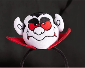 Close-up of plush vampire headband for Halloween with detailed red collar and soft texture