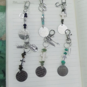 Detailed view of vintage western saddle charms with turquoise beads and metal crosses