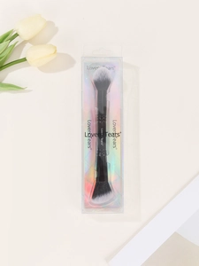 Close-up of double-ended dual head powder and highlight makeup brush in branded packaging