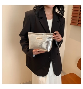 Silver metallic bag detail with FASHION BAG label and wrinkled mirror leather texture