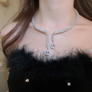 Detail of a luxury choker with double-row crystals and asymmetric pear-shaped pendants