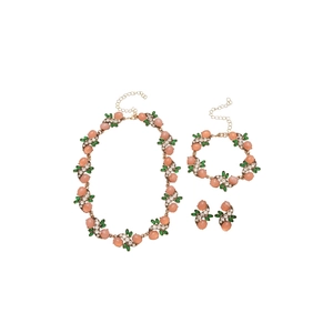 Vintage jewelry set with pink oval resin gems and green accents on a white background