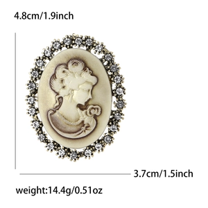 Vintage relief lady head brooch with rhinestones and size specs on white background