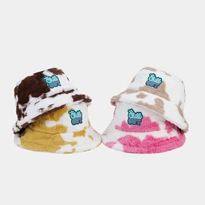 Stylish plush bucket hat with cow print pattern and Chill OUT embroidery for winter warmth