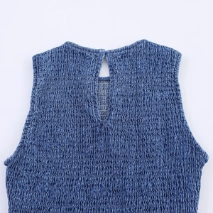 Detailed close-up of honeycomb smocking and back keyhole closure on blue denim-style dress