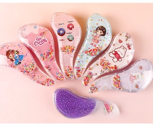 Macro detail of transparent cartoon hair combs with colorful faux sugar needle fillings