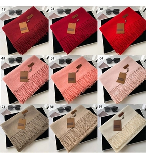 Detailed grid of cashmere-like scarves in nine colors with elegant fringe and brand tags