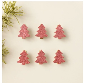Set of 6 pink glitter Christmas tree wooden clips on beige background with pine branch