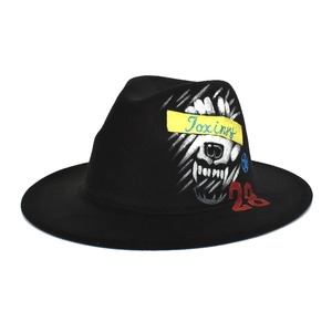 Detail of hand-painted street art graffiti and Toxinny lettering on black fedora hat