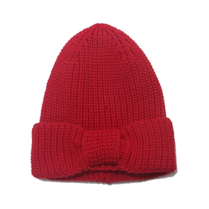 Red knit beanie for children featuring a large decorative bow for winter warmth