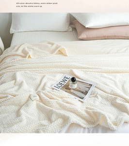 Close-up of off-white waffle weave texture on soft cotton flannel blanket fabric