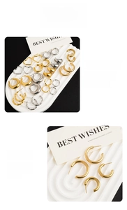 Detail of vacuum plated gold and silver bamboo hoop and heart shaped steel earrings
