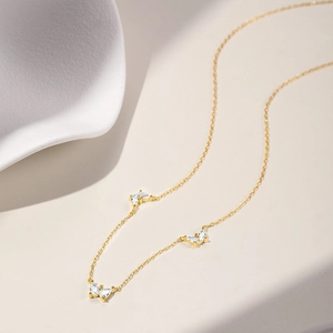 Macro shot of gold butterfly necklace with sparkling marquise-cut zircon pendants