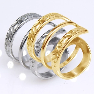 Macro detail of gold and silver steel rings with unique textured spiral design