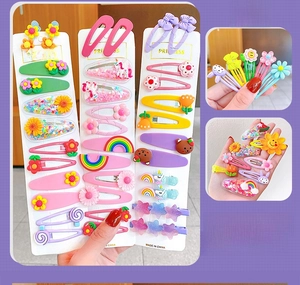 Detail of colorful cartoon hair clips featuring rainbows and flowers on card