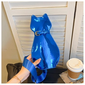 Detailed close-up of glossy electric blue cat-shaped crossbody bag with gold buckle
