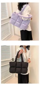 Detail of quilted puffer tote bags in purple and black with soft padded square patterns